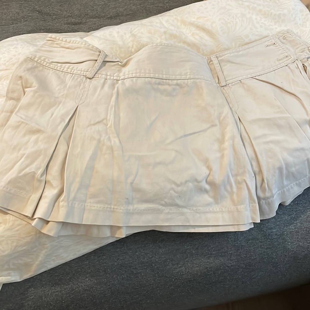 90’s style pleaded khaki skirt. Sits low on your waist buttons on the side